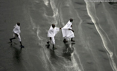 Muslim pilgrims run for cover as heavy rain streams down a road in the holy city of Mecca on November 25, 2009. An estimated 2.5 million Muslims have converged on Mecca for the annual hajj pilgrimage, as workers toil round the clock to complete construction projects designed to avoid deadly stampedes. 