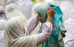A mother adjusts her daughter's headscarf before a prayer on the occasion of Eid al-Adha at Jakarta's largest mosque, the Istiqlal on November 27, 2009 in Indonesia.